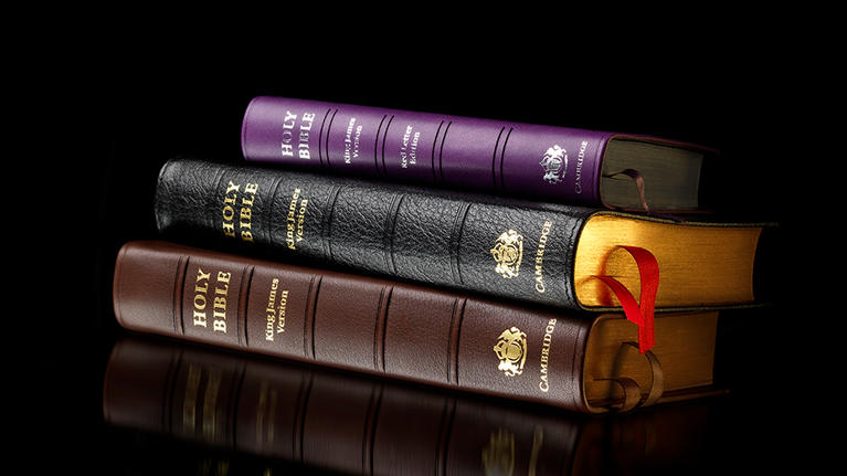 stack of bibles on a black background