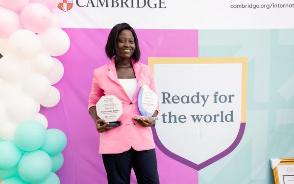 Portia Dzifa Dzilah smiling at camera holding awards